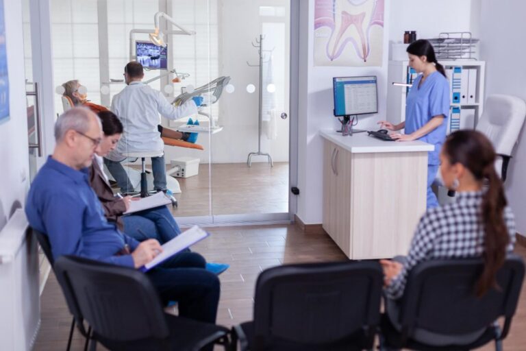 Dental clinic waiting area with patients and staff