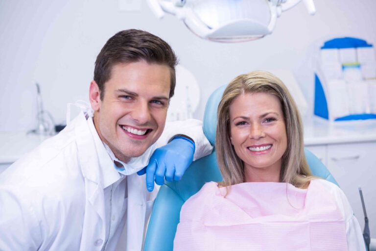 Smiling patient with dentist after a successful dental treatment.